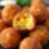 A close-up view of golden fried mac and cheese balls with a crispy texture.